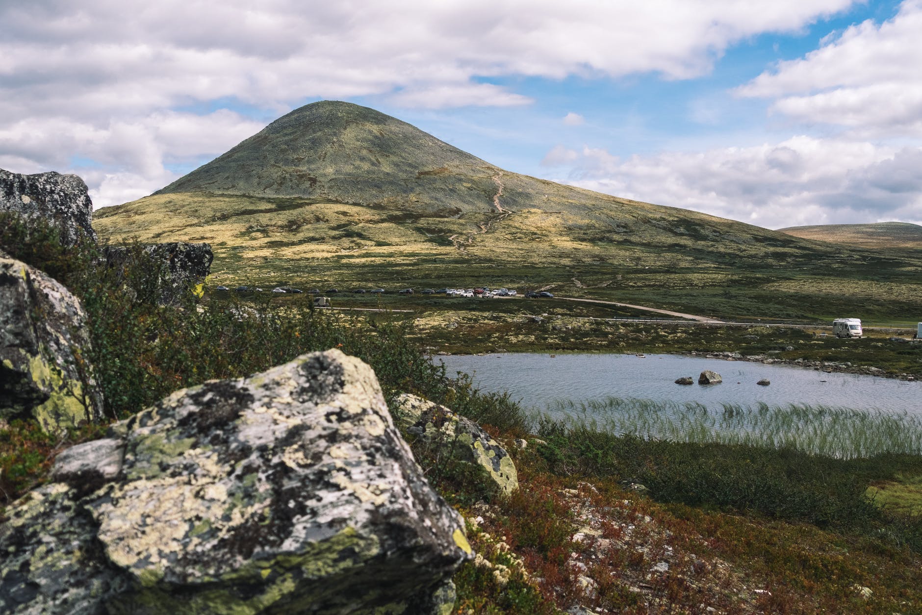 high mountain in valley near calm lake